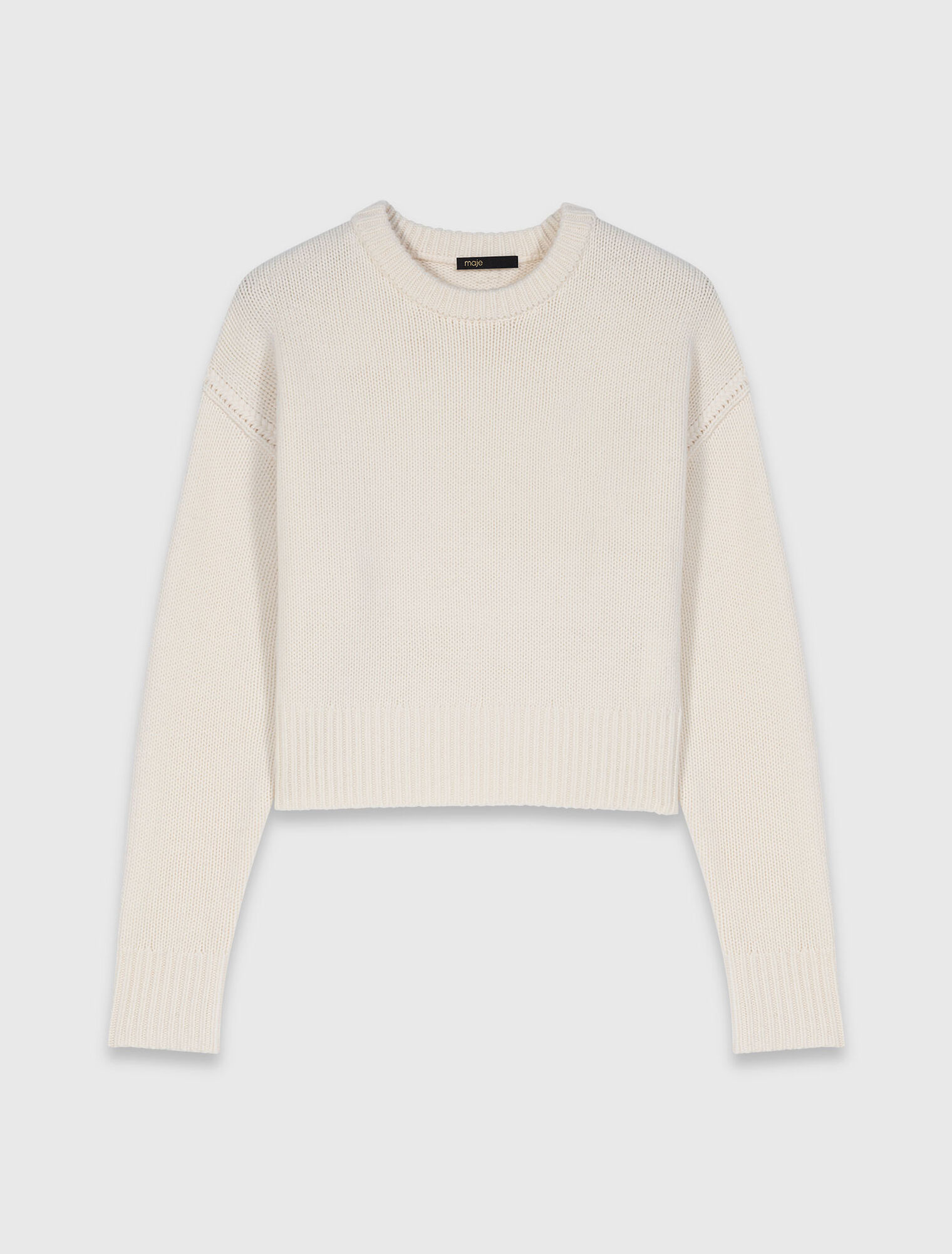 Jumper with floral brooch