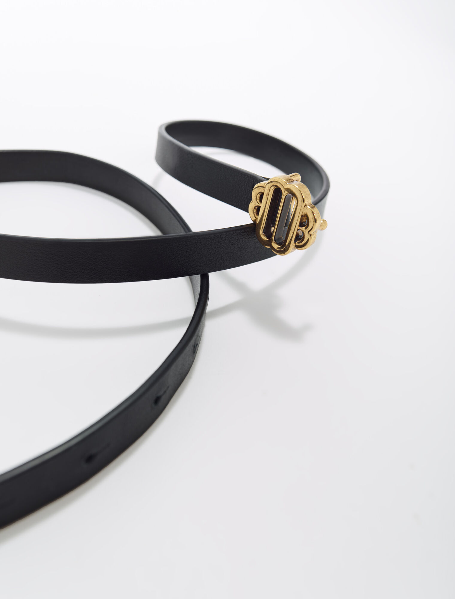 Narrow black leather belt gold buckle